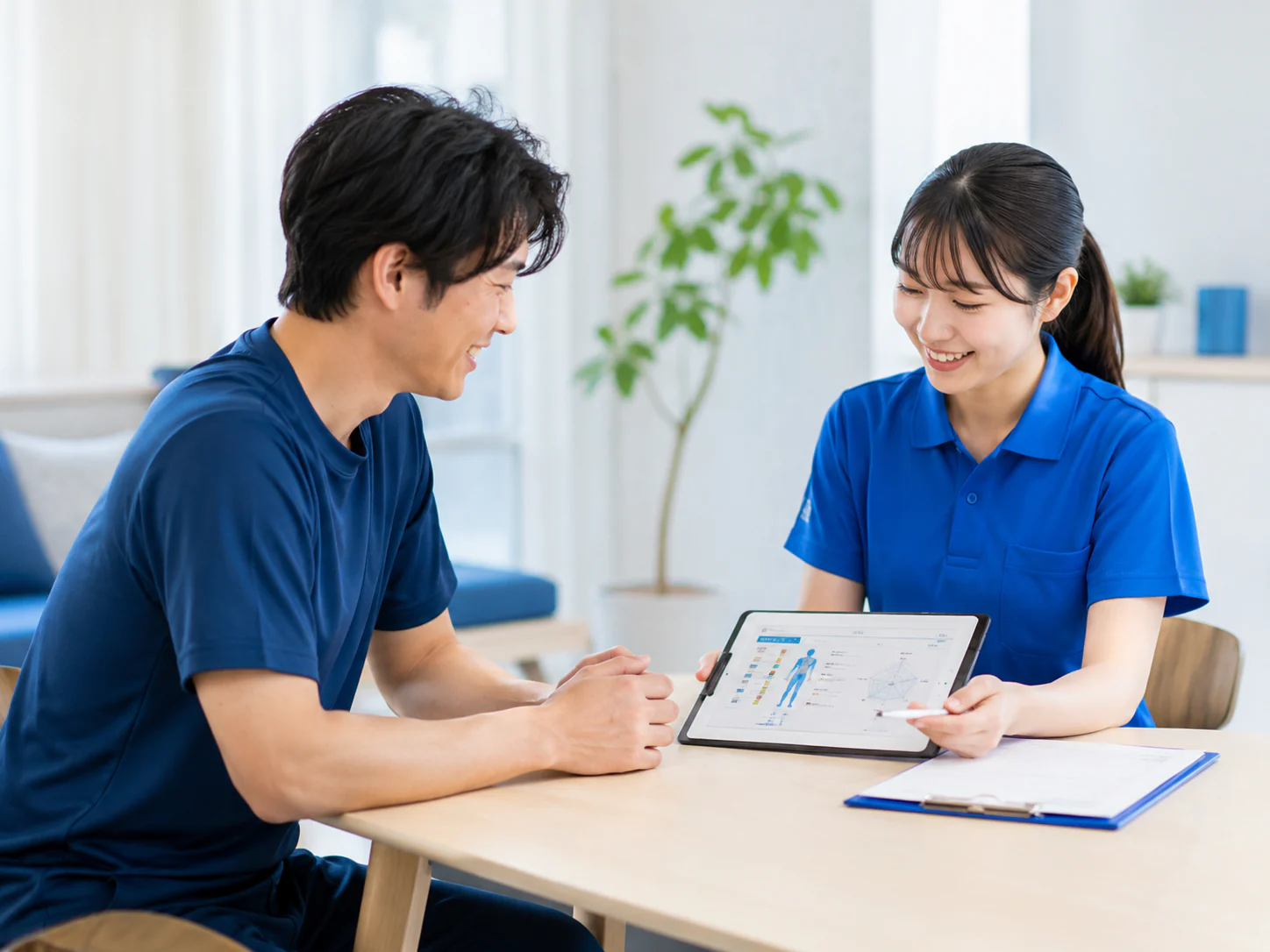 タブレットを囲んで健康状態を確認する相談風景